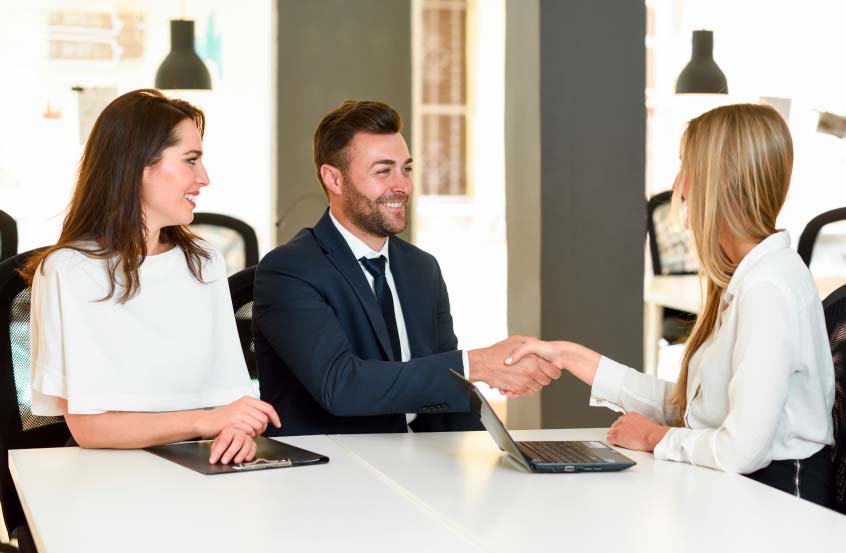 smiling-young-couple-shaking-hands-with-insurance-agent-1-(2)