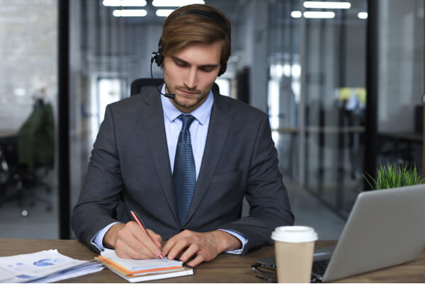 smiling-male-business-consultant-with-headphones-sitting-modern-office-video-call-looking-laptop-screen-man-customer-service-support-agent-helpline-talking-online-chat 4 (1)