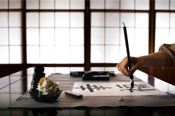 woman-practicing-japanese-handwriting-home 1 1 (1)