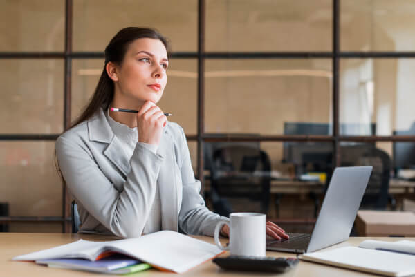 contemplating-businesswoman-sitting-front-laptop-office (1) 2 (1)